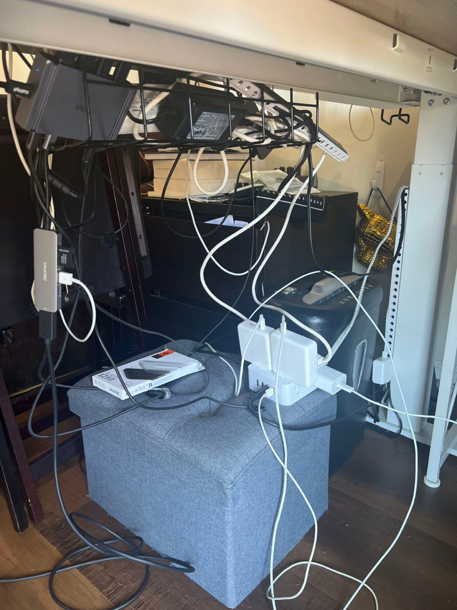 01 tangled mess of wires under a standing desk